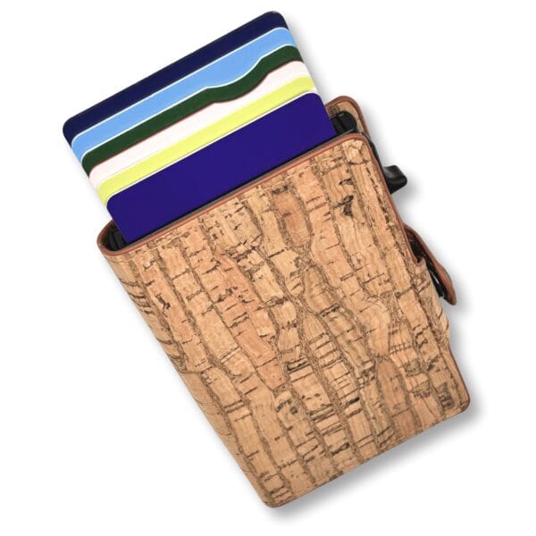 Diagonally placed blue panel with wavy light blue, green, pink, and yellow stripes resting on a cork surface.